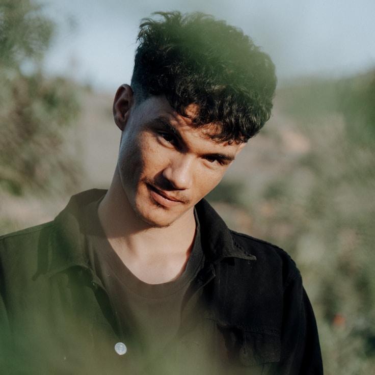 Kaveri Mehta, Lead Design Curator at StudioLeafMarket, reviewing corporate floral arrangements